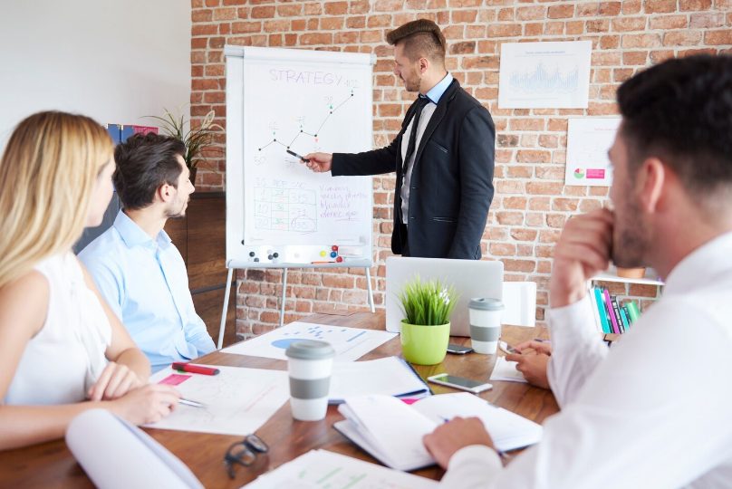 Coach professionnel présentant une stratégie d'entreprise lors d'une session de formation