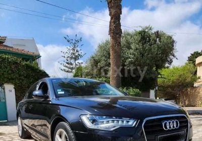 Audi A6 S-Line noire 2015 vue avant trois quarts stationnée sur une rue à Ben Arous